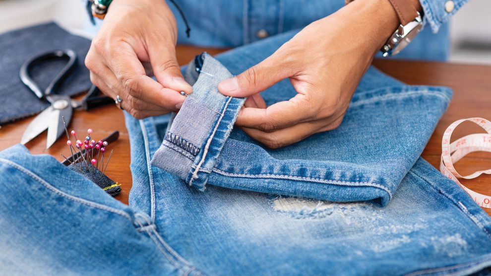 woman mending ripped jeans