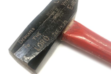 Hammer carved with scripture used for Ploughshares action