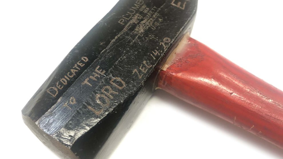 Hammer carved with scripture used for Ploughshares action