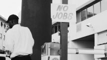 Sign posted in street reading "No Jobs"