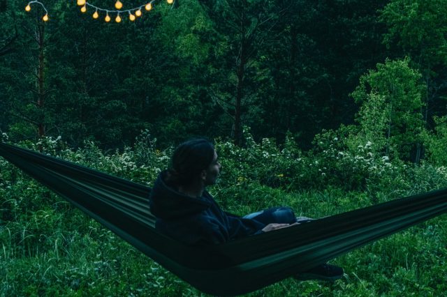 person sitting in a hammock