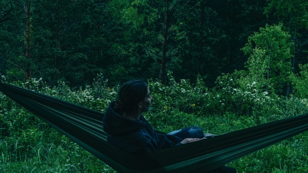 person sitting in a hammock