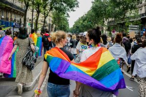 Two women carrying pride flag