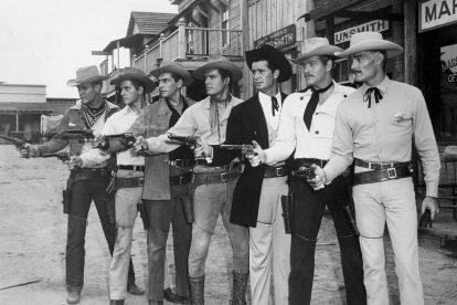 Line of gunslingers in an old western movie