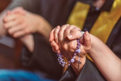 Holding hands while praying the rosary