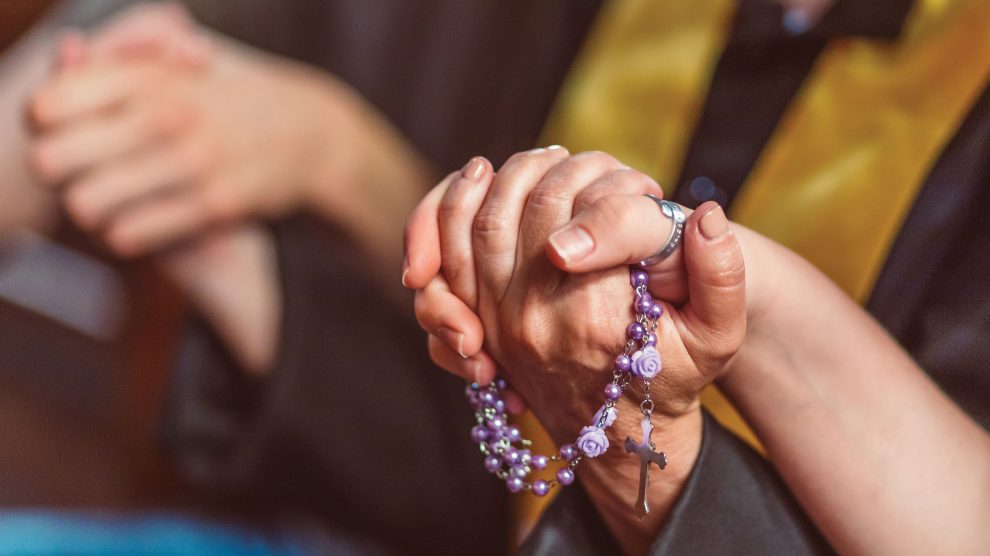 Holding hands while praying the rosary