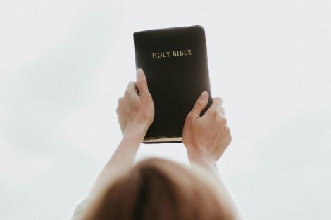 person holding up a bible