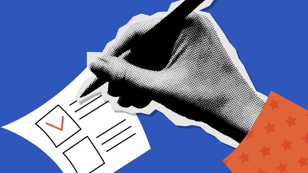 Hand checking a box on a ballot