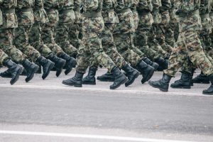 Soldiers marching in formation wearing camouflage