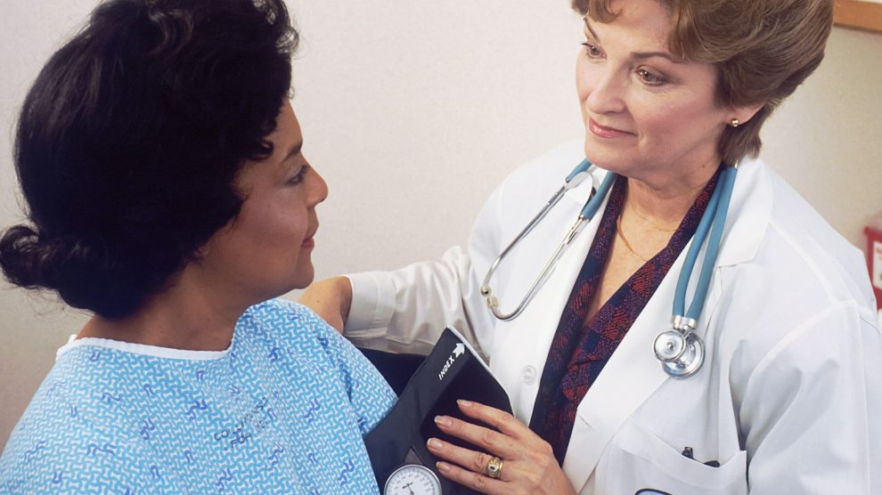 Doctor takes a patient's blood pressure