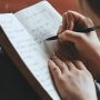 u-s-catholic-person-writing-in-journal