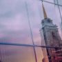 u-s-catholic-church-spire-reflected-on-glass-skyscraper