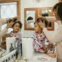 u-s-catholic-mother-brushing-daughters-hair