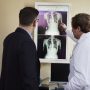 two men look at an xray
