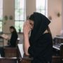 A woman wearing a veil in church