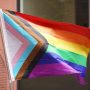 Pride flag in front of brick building