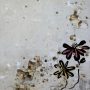 Flowers painted over bullet holes in a wall