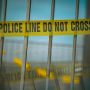 Crime scene tape on a gate