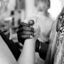 Black person and white person grasping each other's hand