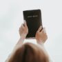 Person lifting Bible into the air