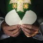 Priest breaking the Eucharit
