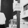 Sign posted in street reading "No Jobs"