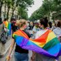 Two women carrying pride flag