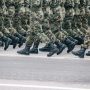 Soldiers marching in formation wearing camouflage