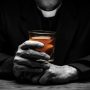 priest-holding-glass-of-whiskey