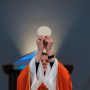 priest-holding-up-eucharist-during-mass