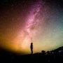 silhouette-of-person-looking-up-at-starry-night-sky