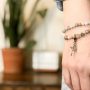 woman-wearing-bracelet-with-cross-and-miraculous-medal